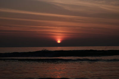 Scenic view of sea against romantic sky at sunset