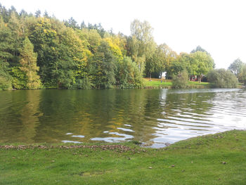 Scenic view of lake and trees against sky