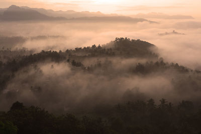 Scenic view of silhouette mountains against sky during sunset