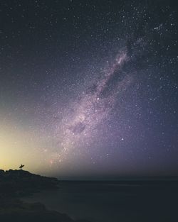 Scenic view of sea against star field at night