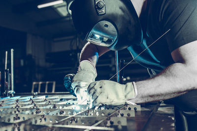 Midsection of man working in factory