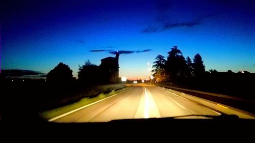 Cars moving on road against sky