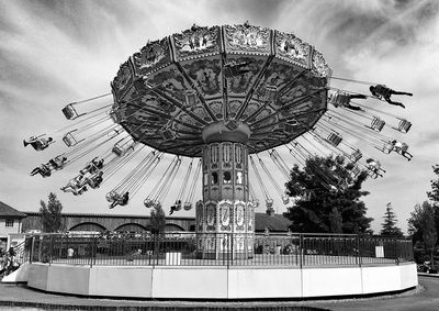 Low angle view of ferris wheel against sky