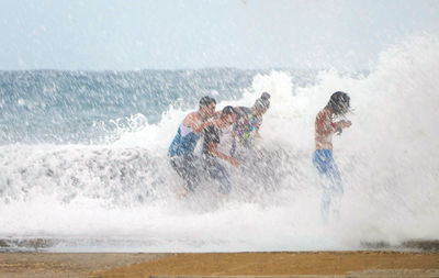 People surfing in sea