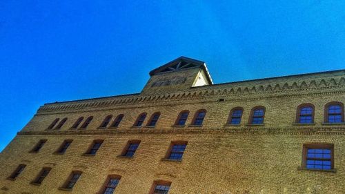 Low angle view of building against clear blue sky