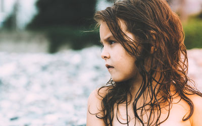 Close-up of serious shirtless girl looking away