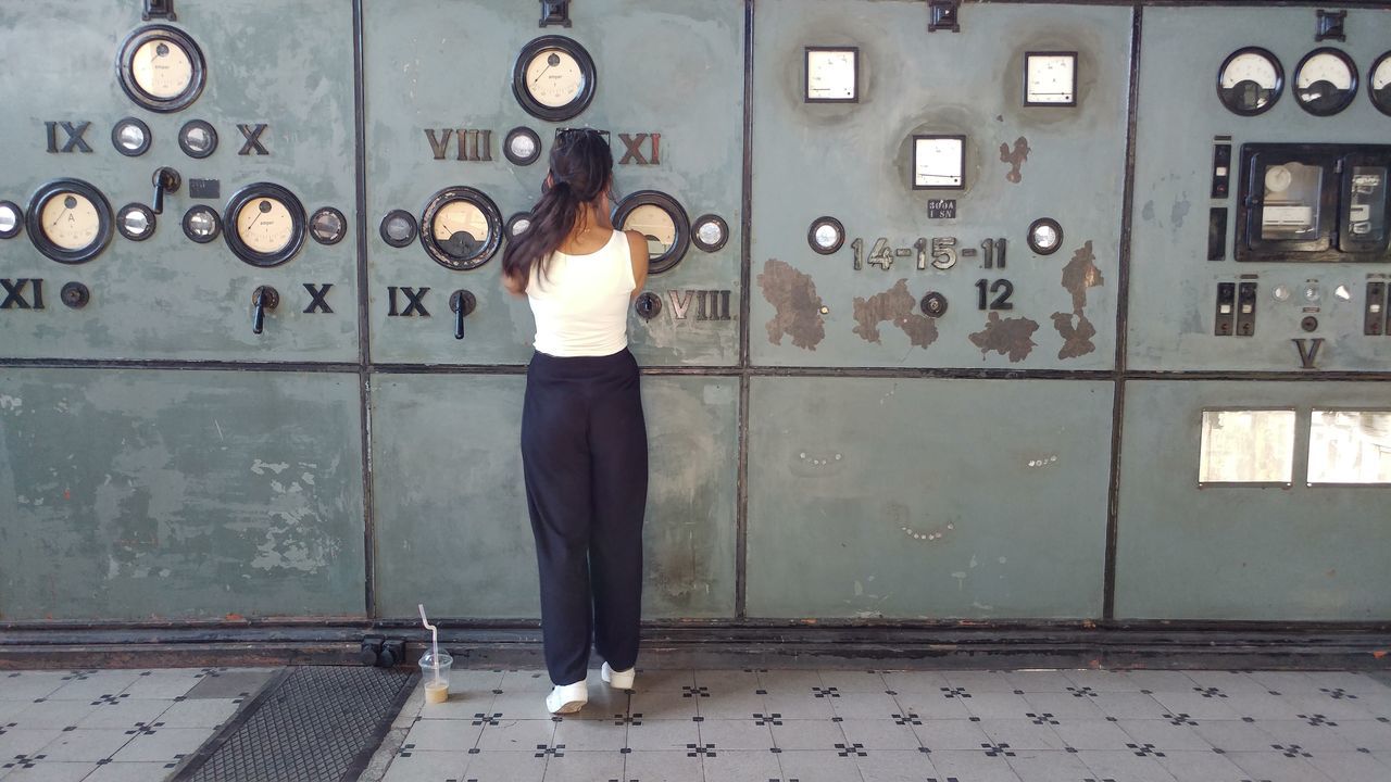 full length, women, one person, only women, standing, one woman only, corporate business, indoors, adult, clock, young adult, adults only, business, control panel, young women, time, people, one young woman only, day