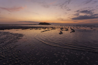 Scenic view of beach against sky during sunset