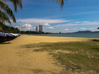 View of beach against cloudy sky