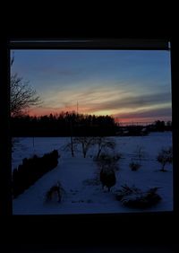 Scenic view of lake against sky at sunset