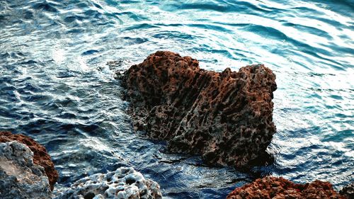 High angle view of rocks in sea
