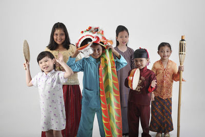 Children in various clothing against white background