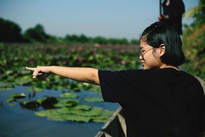 Girl pointing at lake