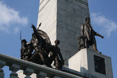 Low angle view of statue against sky