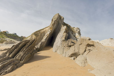 Low angle view of rock formation against sky