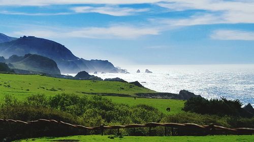 Scenic view of sea against cloudy sky