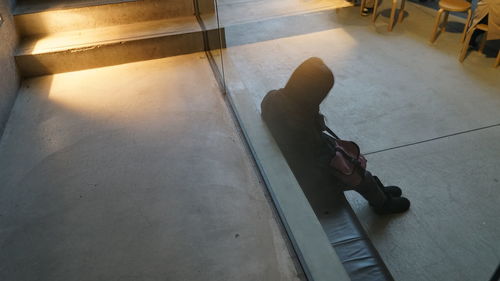 Low section of woman sitting on tiled floor