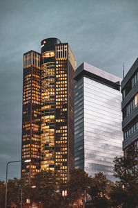 Low angle view of illuminated buildings against sky at dusk