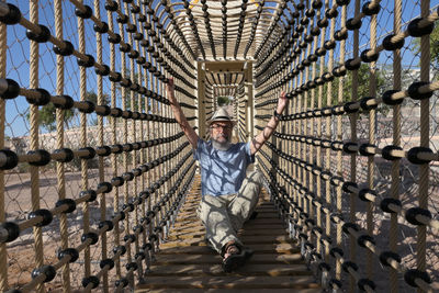 Senior man sitting in a amusement park 