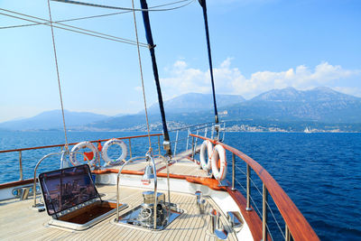 Cropped image of boat on sea against mountains