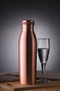 Close-up of wineglass on table against wall