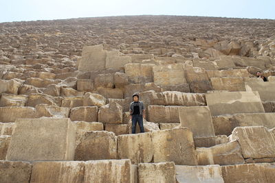 Photo me 2013 , full length of man standing on stone wall , gize