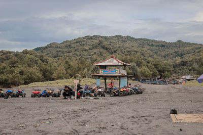 People on beach against sky