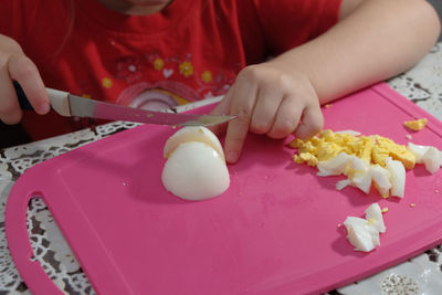 Close-up of hand holding ice cream on table