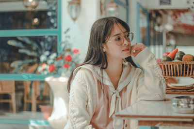 Portrait of woman sitting at restaurant table