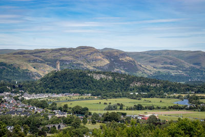 Scenic view of townscape and mountains against sky