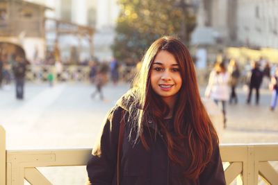 Portrait of young woman in city