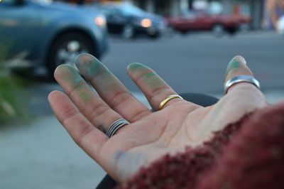 Cropped hand of woman gesturing in city