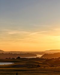 Scenic view of landscape against sky during sunset