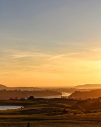 Scenic view of landscape against sky during sunset