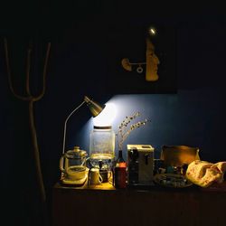 Close-up of illuminated lamp on table at home