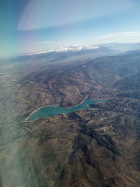 Aerial view of sea and landscape against sky