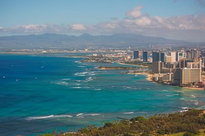 Scenic view of sea and city against sky