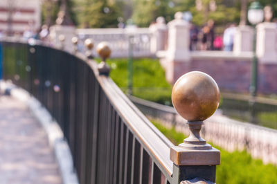 Close up fence handrail in public park in evening time.