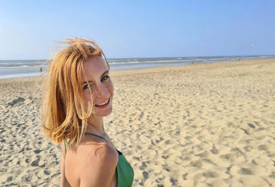 Side view of woman standing at beach