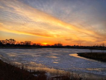 Scenic view of river during sunset