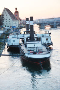 Boats in harbor at sunset