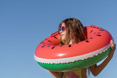 Portrait of a young girl with an inflatable rubber ring on a beach holiday in turkey.