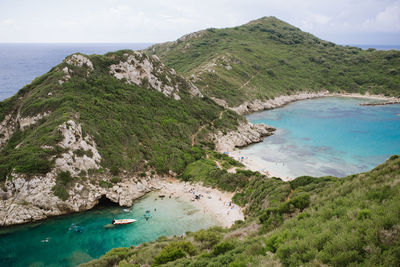 High angle view of sea and mountains against sky