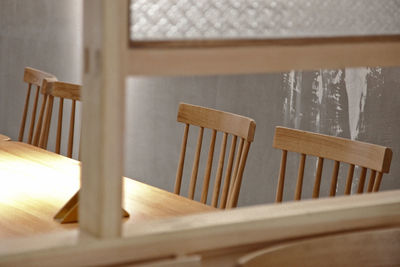 Close-up of chairs on table at home