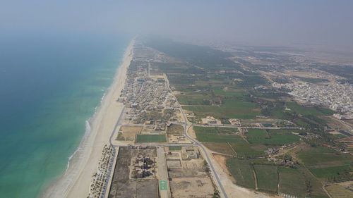 High angle view of sea and land against sky