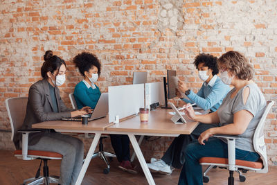 Friends sitting in front of laptop