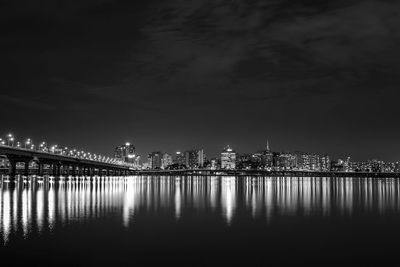 Illuminated city at waterfront