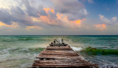 Pier over sea against sky