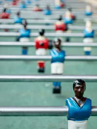 People relaxing on railing against blurred background