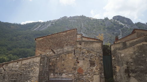 Old building on mountain against sky